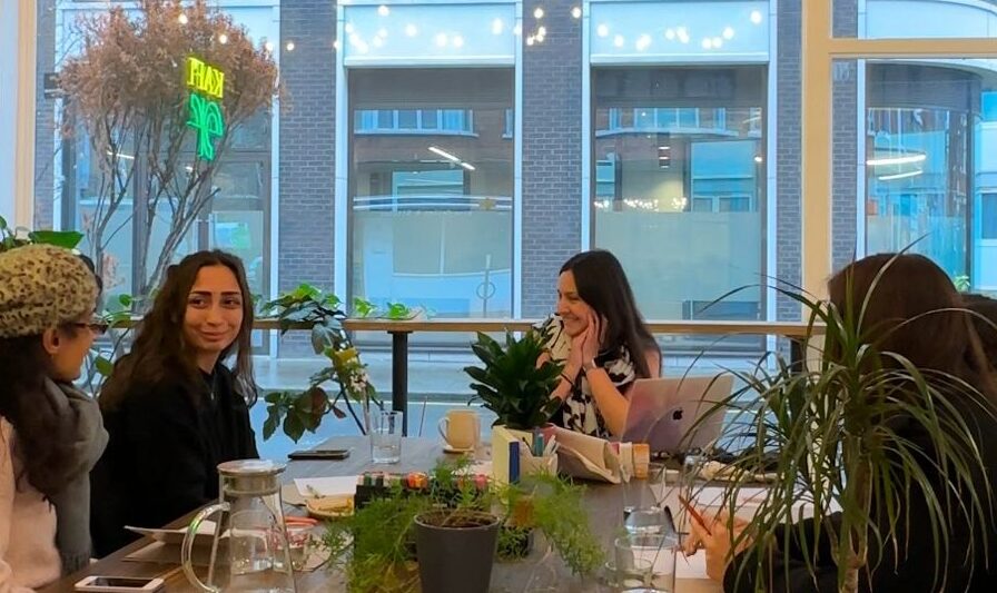 A cozy London café workshop journaling, meditating, and creating during a creativity session designed to overcome creative blocks and spark inspiration.